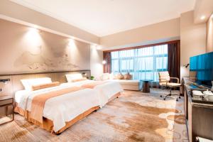 Postel nebo postele na pokoji v ubytování Jin Jiang Pine City Hotel + 37 fotografií