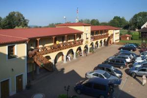 a parking lot with cars parked in front of a building at Hotel Resort Stein in Cheb