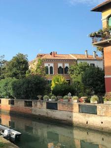 a house on the side of a river at Villa Contarini B&B in Venice-Lido