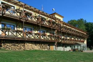 a building with flower boxes on the side of it at Hotel Resort Stein in Cheb