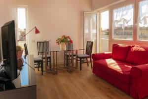 a living room with a red couch and a table at Garibaldi's Camp in Rome