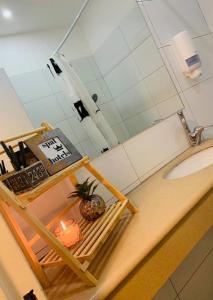 a bathroom counter with a pineapple on a shelf next to a sink at Motel Hofim in Bat Yam