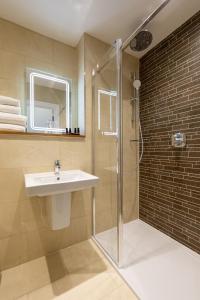 a bathroom with a sink and a shower at Sandhills Apartments, Mudeford in Christchurch