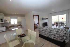 a kitchen and a living room with a table and a couch at DIFFERENTFLATS Mexico in Salou