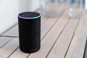 a black speaker sitting on top of a wooden table at Sandhills Apartments, Mudeford in Christchurch