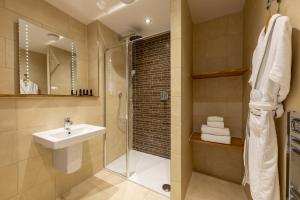 a bathroom with a sink and a shower at Sandhills Apartments, Mudeford in Christchurch