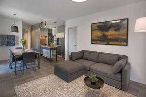 a living room with a couch and a table and a kitchen at Luxury apartment Marjan - Black in Split