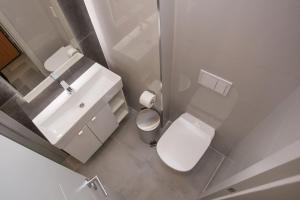 a white bathroom with a toilet and a sink at Luxury apartment Marjan - Black in Split
