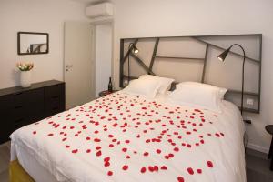 a bedroom with a bed with red roses on it at Luxury apartment Marjan - Black in Split