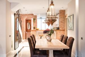 a dining room with a wooden table and chairs at Marbella Center Beachfront with Private Patio in Marbella
