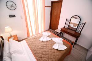 A bed or beds in a room at To Gefyraki Rooms