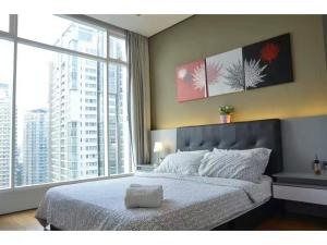 a bedroom with a bed and a large window at Soho Suites KLCC by LX Suites 2 in Kuala Lumpur