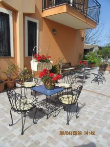 
a table with chairs and a table cloth at B&B Villa Maria Giovanna in Giardini Naxos
