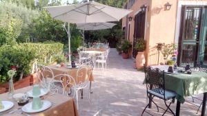
a table and chairs with an umbrella on a patio at B&B Villa Maria Giovanna in Giardini Naxos
