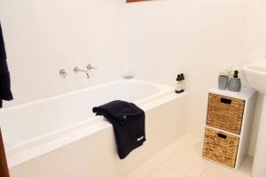 ein weißes Badezimmer mit Badewanne und Waschbecken in der Unterkunft Nagoondie Studio in Healesville + 17 Fotos