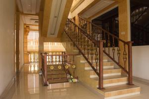 a staircase in a building with wooden railings at RedDoorz near MM UGM in Yogyakarta