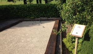 a bunch of birds sitting on the ground next to a sign at B&B Villa Roma in Durbuy