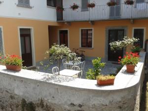 a balcony of a house with potted plants on it at Casa Giardinetto in Stresa