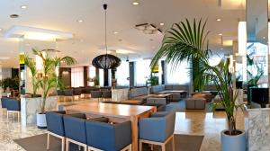a hotel lobby with a table and chairs at Hotel Bernat II 4*Sup in Calella