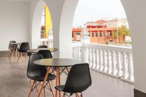 a row of tables and chairs on a balcony at Hostal Castillo in San José de la Rinconada
