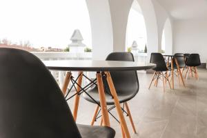 a group of chairs around a table in a room at Hostal Castillo in San José de la Rinconada