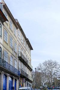 a building with balconies on the side of a street at Mayor's Apartments in Porto