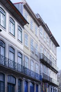 a large building with balconies on the side of it at Mayor's Apartments in Porto