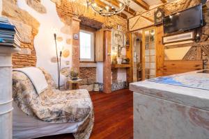 a room with a bed and a tv in a room at Romantic Medieval Apartment in Lisbon