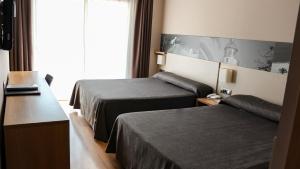 Postel nebo postele na pokoji v ubytování Hotel Bernat II 4*Sup