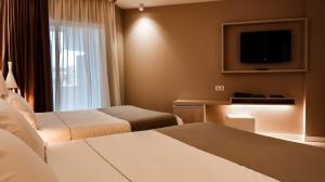 Postel nebo postele na pokoji v ubytování Hotel Bernat II 4*Sup