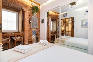 a bedroom with two beds and a mirror at Romantic Medieval Apartment in Lisbon