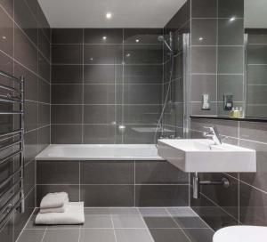 a bathroom with a sink, toilet, and bathtub at SACO Bristol - Broad Quay in Bristol