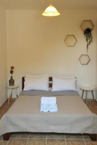 a bedroom with a bed with two towels on it at Villa Maraki in Agia Paraskevi