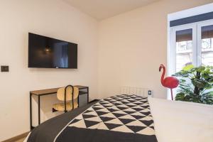 a bedroom with a bed and a tv on a wall at Cantalojas by Staynnapartments in Bilbao