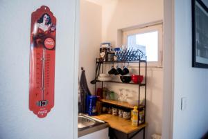 a kitchen with a red thermometer hanging on a wall at Travel Homes - The EastSide, Parking and downtown in Colmar