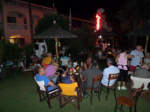 a group of people sitting in chairs at a party at Assamaris in Asprovalta