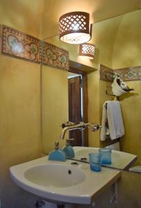 a bathroom with a sink and a mirror at Agriturismo Baglio Pollicarini in Pergusa