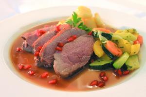 a plate of food with meat and vegetables at Hotel An der Linde in Neckarsulm