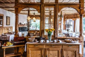 a kitchen with a table with a vase of flowers at Hotel Schönegg in Wengen