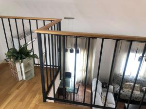 a room with a staircase with a couch and a table at Vivienda Rural El Ejido in El Real de la Jara