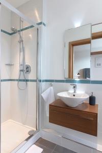 a bathroom with a sink and a shower at Hampden Apartments - The Charles in Windsor +24 photos