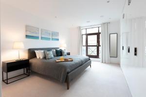 a bedroom with a bed with a table on it at Hampden Apartments - The Charles in Windsor