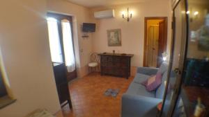 a living room with a blue couch and a table at Villetta Marina in Lipari