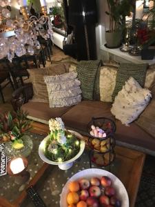 a living room with bowls of fruit on a table at Hotel Lilton in Ängelholm