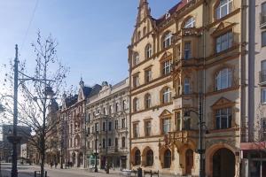 a large building on a street in a city at Marilyn Apartment in Łódź