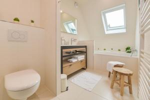 a bathroom with a toilet and a sink at La Maison de Pierre et Valérie St Leonard Honfleur in Honfleur