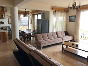 a living room with a couch and a table at Villa Aphrodite in Peyia