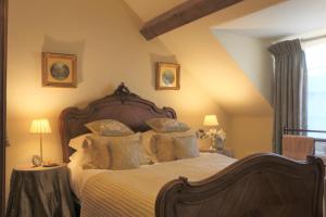 a bedroom with a large bed with pillows at Oundle Bespoke Apartments in Oundle