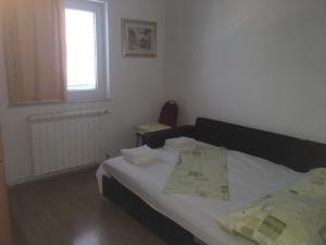 Postel nebo postele na pokoji v ubytování Apartments Lucija