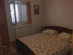 Postel nebo postele na pokoji v ubytování Apartments Lucija